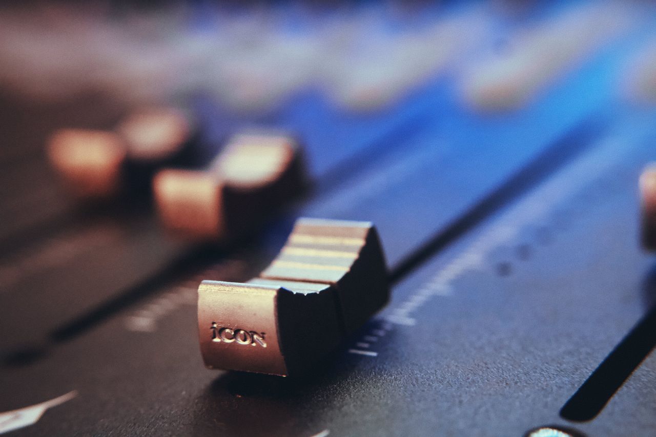 about-01 Detailed view of an audio mixer fader and slider with a selective focus effect.
