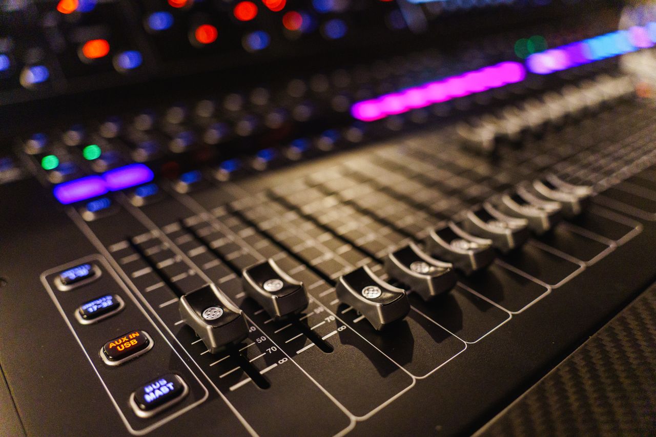 hero-img-01 Detailed view of an advanced audio mixing console, perfect for studios.